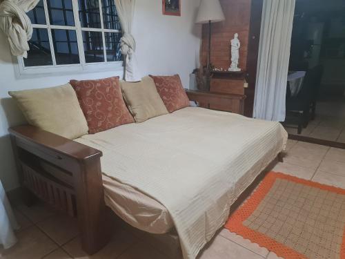 a bed in a room with a couch and a window at Oasis casa da melody in Munro