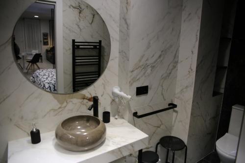 a bathroom with a sink and a mirror at E&R-1 Plaza España in Salamanca