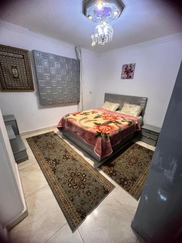 1 dormitorio con 1 cama y 2 alfombras en el suelo en شقة فندقية قريبه من مطار القاهره الدولي, en El Cairo