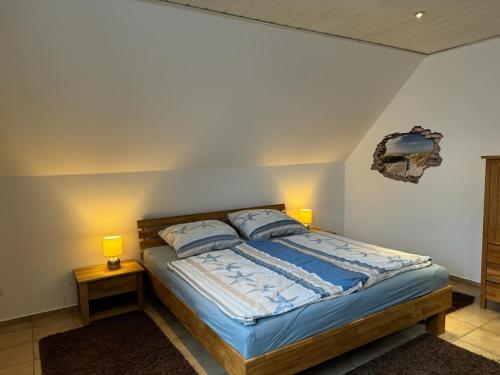 a bedroom with a bed with two lamps on two tables at "Alte Sparkasse" Nr1 in Landkirchen
