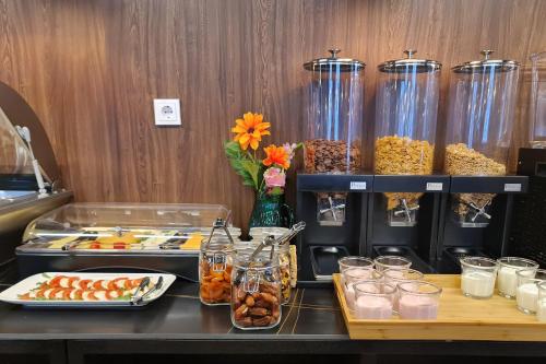 a buffet line with food and jars of food at Hotel Fogo Amsterdam in Amsterdam