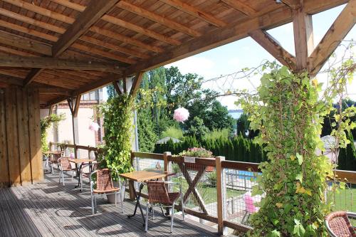 a patio with tables and chairs and vines at Clos De La Vaupalière - Rouen in La Vaupalière