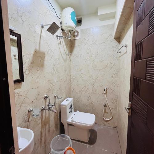 a bathroom with a toilet and a sink and a shower at Sundaram Residency in Chennai