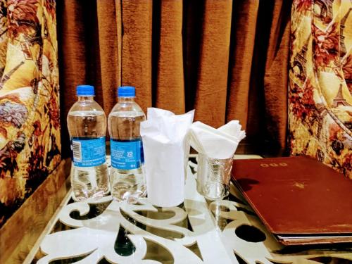 dos botellas de agua están sentadas en una mesa en Grand Hill mall road Mcleodganj, en Dharamsala