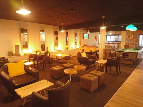 a restaurant with couches and tables and a pool table at Clos De La Vaupalière - Rouen in La Vaupalière