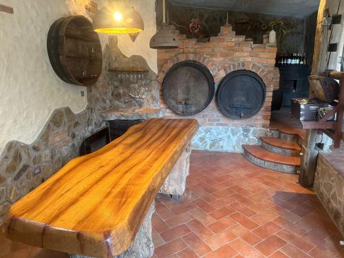 a wooden bench in a room with a stone fireplace at ZIDANICA MEDLE in Otočec