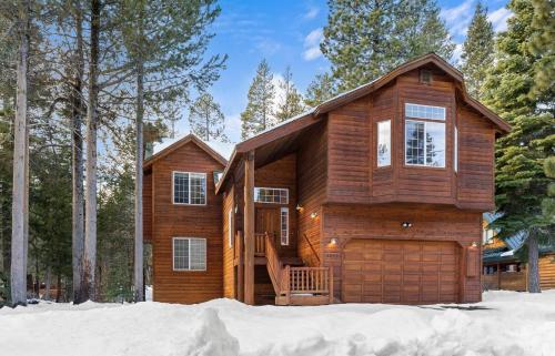a wooden house with a garage in the snow at Cascade Woods in Tahoma