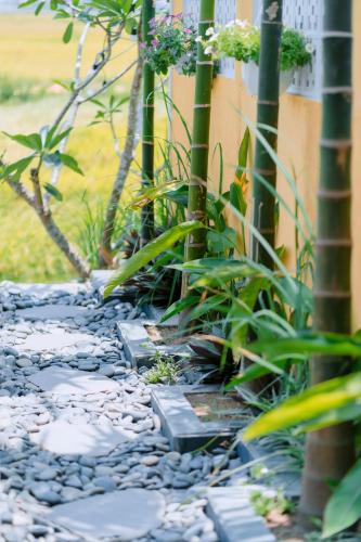 a pebble walkway in front of a building at BS Jade Home Hội An in Hoi An