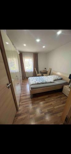 a bedroom with a bed and a table with chairs at Privatzimmer , mit sehr guter Verkehrsanbindung in Nuremberg