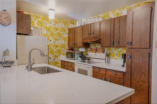 a kitchen with wooden cabinets and a white refrigerator at O'Hara's Place in Kings Beach