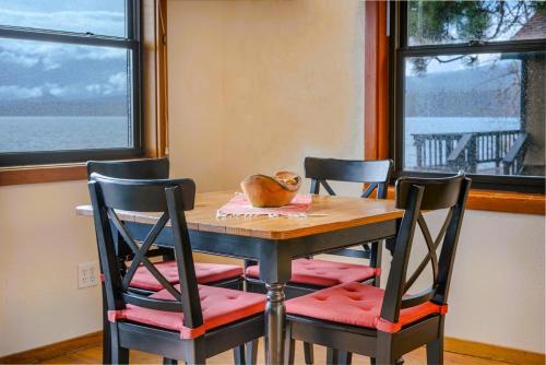 a dining room table with two chairs and a bowl on top at On The Beach in Tahoe Vista