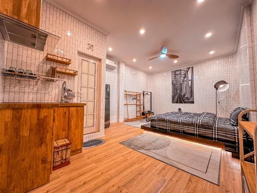 a bedroom with a bed in a room with wooden floors at La Casa Di Dicembre in Hanoi
