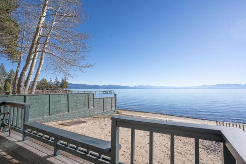 a bench on a dock next to a body of water at On The Beach in Tahoe Vista