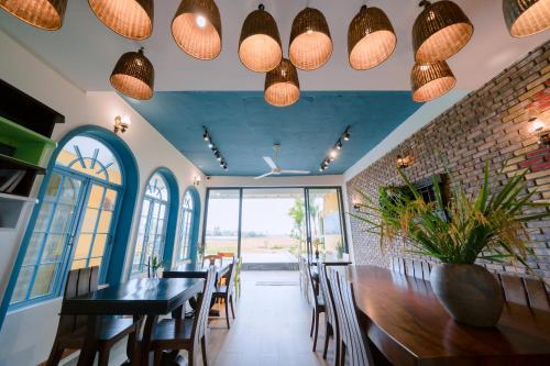 a dining room with a table and some lights at BS Jade Home Hội An in Hoi An
