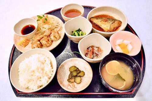 a tray of food with rice and different types of food at Okayama Ekimae Universal Hotel in Okayama