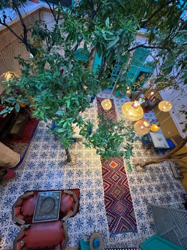 a table with a table cloth with trees on it at Riad Al Nour in Marrakesh