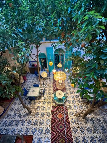 an overhead view of a table under an orange tree at Riad Al Nour in Marrakesh