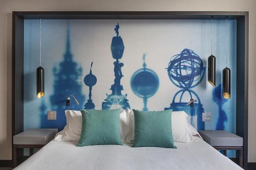 a bedroom with a large bed with blue walls at DUPARC Contemporary Suites in Turin