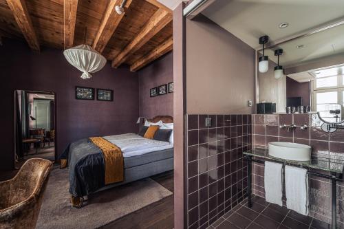 a bedroom with a bed and a bathroom with a shower at Boutique Hotel Spedition a member of DESIGN HOTELS in Thun