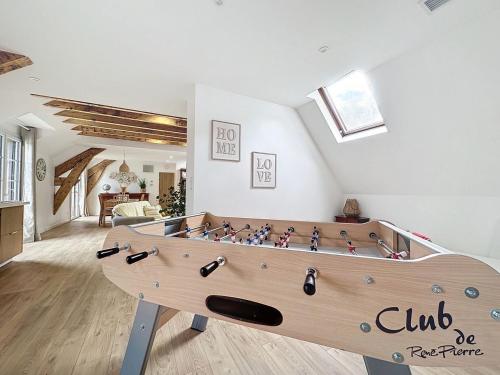 a large wooden foosball table in a living room at [PARENTHESE] Le Pic du Midi - 110m² in Bagnères-de-Bigorre