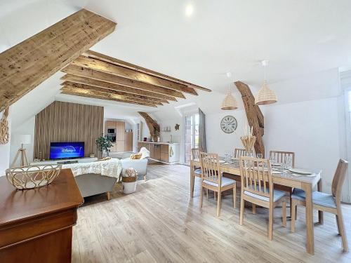 a dining room and living room with a table and chairs at [PARENTHESE] Le Pic du Midi - 110m² in Bagnères-de-Bigorre