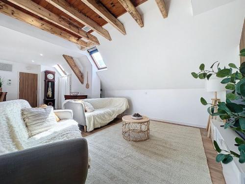 a living room with a couch and a table at [PARENTHESE] Le Pic du Midi - 110m² in Bagnères-de-Bigorre