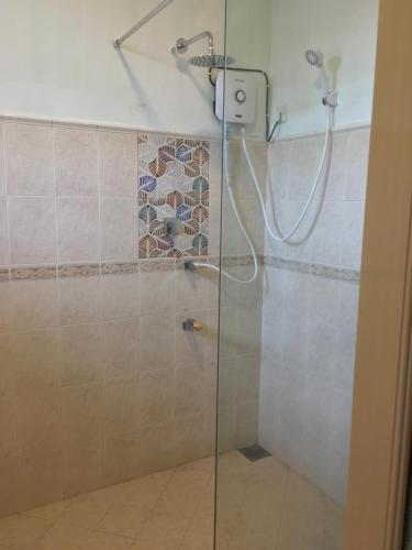 a bathroom with a shower with a glass door at Moon Deck Villa in Katunayaka