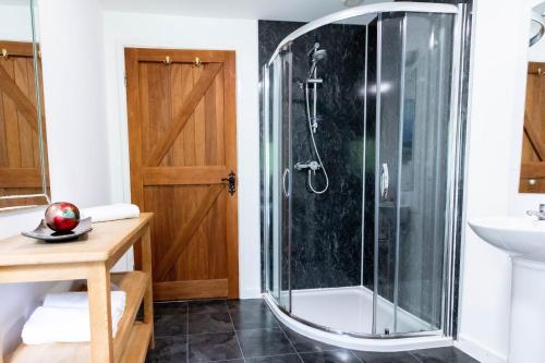 a bathroom with a shower and a sink at Treworgie Barton - Warner in Bude
