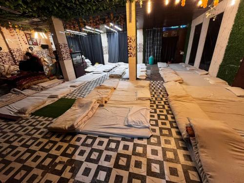 a long line of blankets on the floor of a room at Hotel Green in Kharar