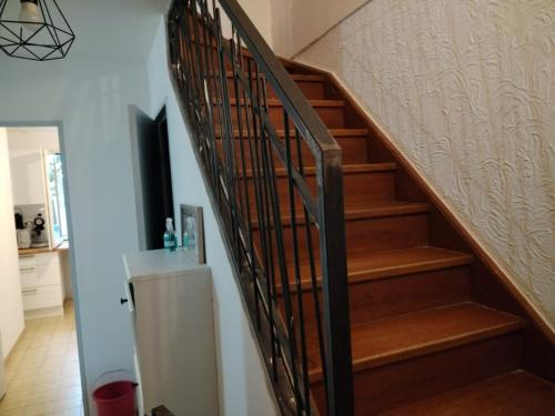 a staircase in a home with wooden steps at Villa Mont D'Or in Manosque