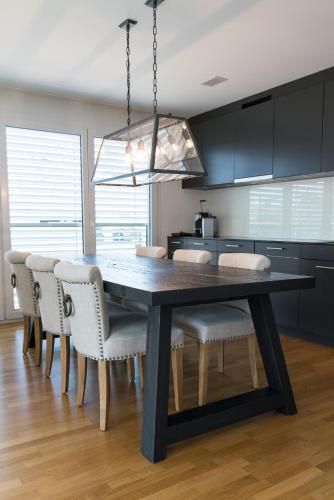 a dining room table and chairs in a kitchen at Boutique Hotel Spedition a member of DESIGN HOTELS in Thun