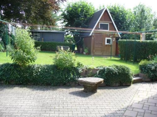 a bench sitting in the middle of a yard at Schillerstrasse in Burgstaedt