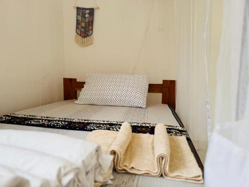a bedroom with two beds with towels on them at Karibu Africa Home in Moshi