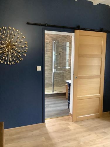 a door leading into a bathroom with a mirror at Maison au Coin, proche St Emilion in Sainte-Terre