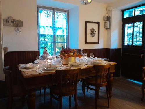 a dining room table with chairs and glasses on it at Bnbook Ca Du Val in Terrabona