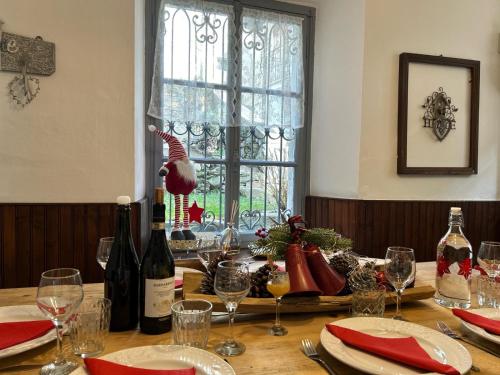 a table with wine bottles and glasses and a window at Bnbook Ca Du Val in Terrabona