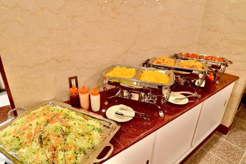 a kitchen with two trays of food on a counter at Yonago Universal Hotel in Yonago