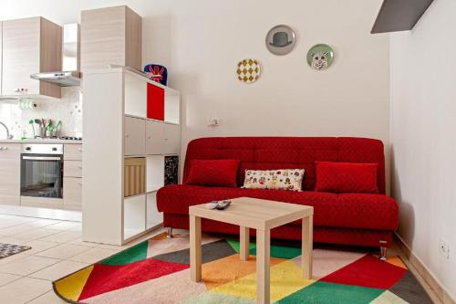 a living room with a red couch and a table at CASA PATTI in Livorno
