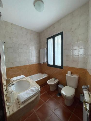a bathroom with a sink and a toilet and a tub at Casa Padriñan in Sanxenxo