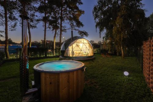 a hot tub and a dome in a yard at Glamping Escape Prague with Hot Tub and Vysehrad Castle View in Prague