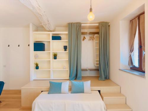 a bedroom with a white bed with blue pillows at Modern Loft Rho Fiera Milano in Rho