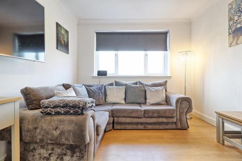 a living room with a couch and a chair at Lavish Rayleigh Apartment - LMV Property in Rayleigh