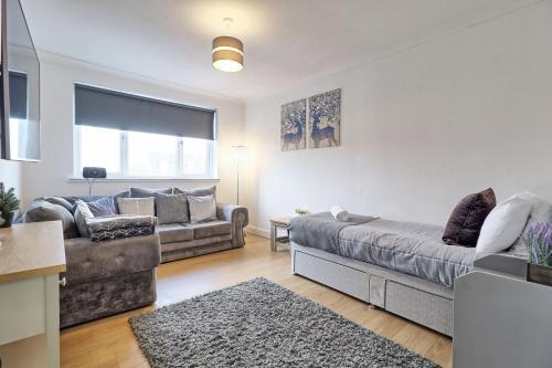 a living room with a couch at Lavish Rayleigh Apartment - LMV Property in Rayleigh