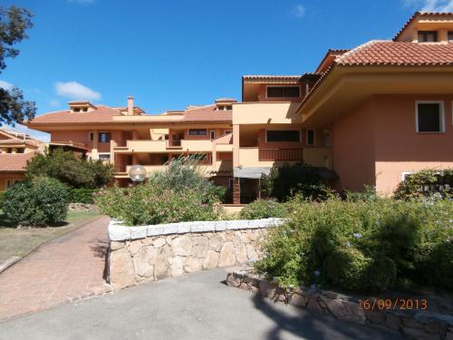 a large house with a stone wall in front of it at Casa Gallo in Santa Marinella