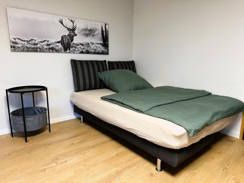 a bed in a room with a picture of a deer on the wall at Rottweiler Ferienwohnung in Rottweil