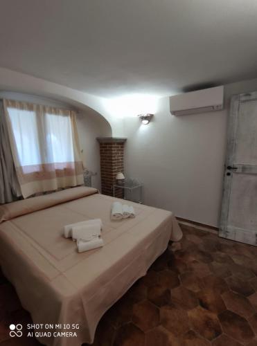 a bedroom with a bed with two towels on it at Casa Gallo in Santa Marinella