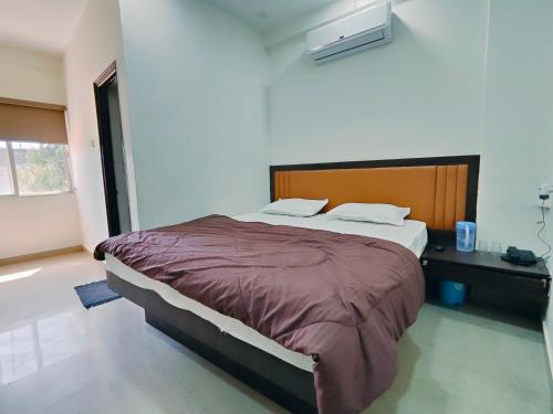 a bedroom with a large bed in a room at Heritage Palace - Bhuj in Bhuj