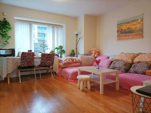 a living room with a couch and a table at Llt Fraser HomeAway in Vancouver