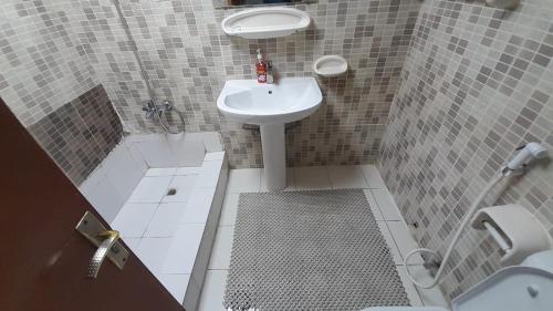 a small bathroom with a sink and a shower at ADMFHR5 in Abu Dhabi