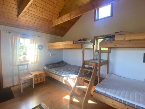 a room with two bunk beds and a bed at Ulvsby Ranch in Karlstad